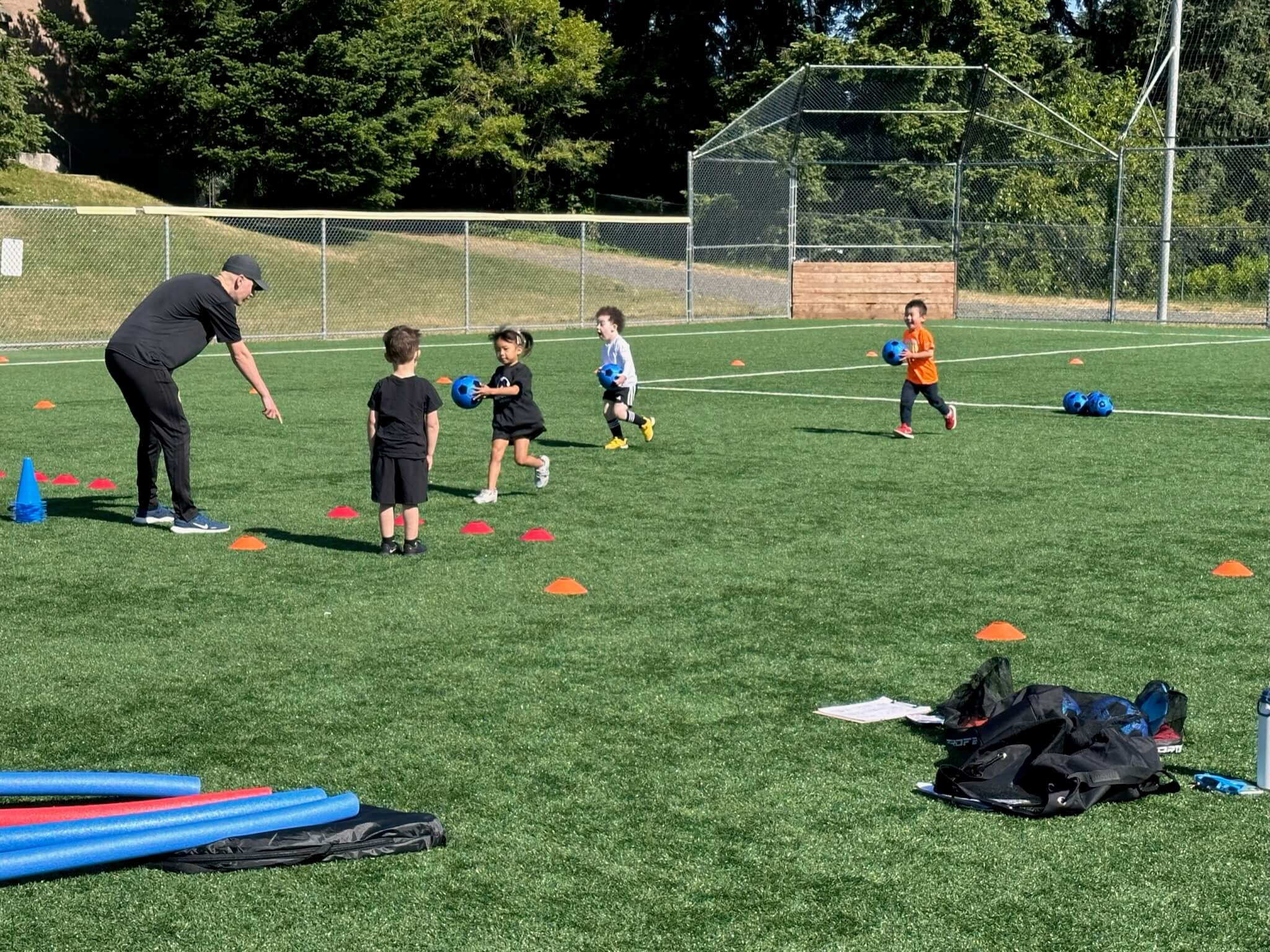 Preschooler setting a ball on top of a cone